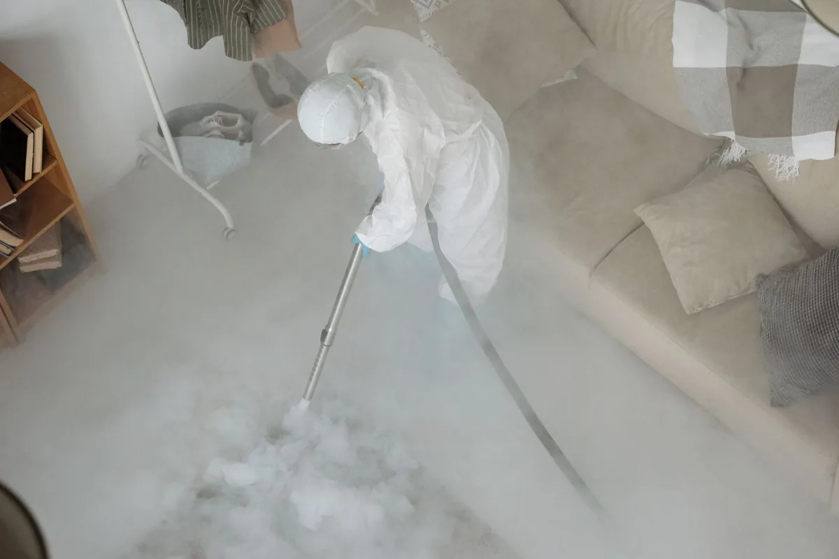 Biohazard cleanup technician in protective equipment, Magna metro township, UT